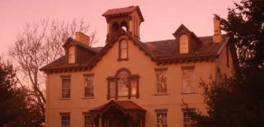 The sunrise casts a pink glow on the facade of President van Buren's home.